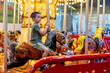 © Inna Reznik/Stocksy - Cute Kid, Riding on a Carousel in an Indoor Park.