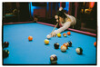 © Nikita Sursin/Stocksy - woman playing pool table snooker game