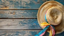 Straw Hat With Colorful Ribbons On Rustic Blue Wooden Background
