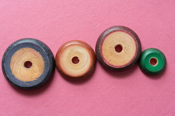 vintage stacking toy pieces on rough pink paper