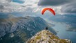 A paraglider is seen preparing to take off from a mountain peak.