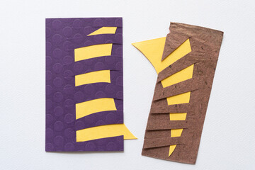 two abstract paper rectangles with stripe cuts shapes on blank paper