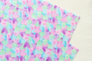 Sticker - layered fabric pieces with heart print pattern on paper