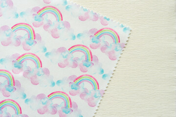 Poster - corner of fabric doily with rainbows and clouds print pattern on crepe paper