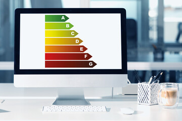 Poster - Energy efficiency rating on display. Workplace with modern computer