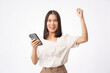 © Pormezz - Happy Asian woman holding a smartphone and winning the prize.