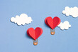 © Marc Tran/Stocksy - Paper cut of Heart Hot air balloons for Valentine's Day celebration
