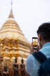 © Alvaro Lavin/Stocksy - Traveler photographing Buddhist temple.