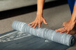 © Studio Firma/Stocksy - Woman rolling up yoga mat