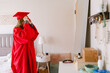 © ByLorena/Stocksy - Red Cap And Gown