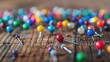 Multicolored push pins on the wooden table. Close up. Selective focus,Colorful push pins on white wooden table. Selective focus.Colored straight pins on wooden table, copy space.
