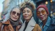 A group of mature female friends posing together in front of the camera. Having fun outdoors at a city street - three mature trendy women having fun together