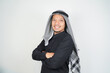 © Aria Armoko - Happy and confident asian muslim man wearing Arab turban sorban standing with crossed arms isolated