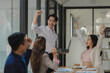 Business partners are congratulating each other on exceeding their sales targets, A group of company employees are very happy after completing a project that their boss intended.
