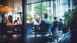 © melhak - Blurry Office Meeting Through Glass Wall: Focusing on Corporate Teamwork and Workplace Dynamics.