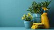 Cleaning supplies with a spray bottle, yellow cloth, and plants on a blue background. Household maintenance and cleanliness concept for design and print. Still life composition with space for text
