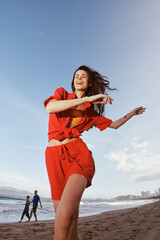 Canvas Print - Joyful Summer Dance: a Smiling Woman Embracing Freedom by the Sea