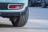 Fototapeta Natura - Close-up of car tires and wheel parked on asphalt roads.