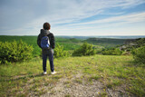 Fototapeta Natura - Boy standing and looking at mountainous landscape.