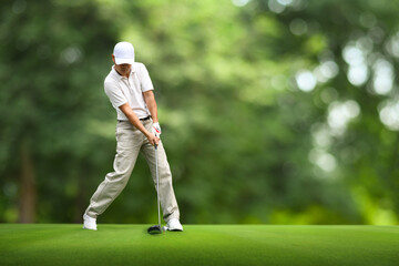 Wall Mural - Motion action of teeing off golf ball with drivers.