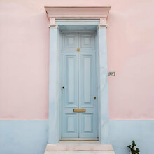 Pastel Pink Building With Light Blue Door And Marble