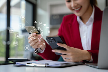 Wall Mural - Businesswoman use computers and smartphone to pay through credit card payment channels. Online shopping Sit at the desk.