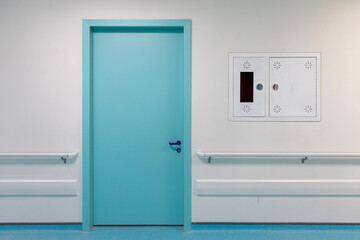 modern hospital corridor with blue doors and flooring