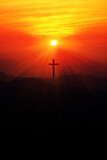 Fototapeta Tulipany - Silhouette of christian cross on the mountain at sunset.