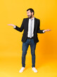 © luismolinero - Full-length shot of business man over isolated yellow background holding copyspace with two hands
