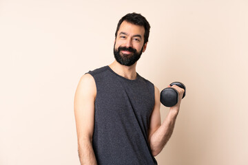 Wall Mural - Caucasian sport man with beard making weightlifting over isolated background keeping the arms crossed in frontal position