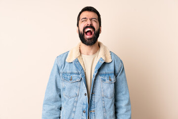 Wall Mural - Caucasian man with beard over isolated background shouting to the front with mouth wide open