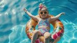 Cute funny toddler girl in colorful swimsuit and sunglasses relaxing on inflatable toy ring floating in pool have fun during summer vacation in tropical resort. Child having fun in swimming pool.