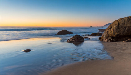 beach and rocks on the pacific ocean coast at sunset