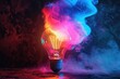 Light bulb with colorful smoke, black background, vibrant colors. Burning lamp in a dark. Glowing effect. Concept of idea, innovation, business creativity. Advertising poster template. Art wallpaper