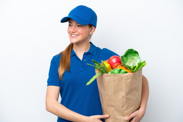Wall Mural - Young delivery woman taking a bag of takeaway food isolated on white background looking side