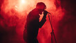 © olindana - Rock musician singer holding a microphone standing on stage singing. Red smoke clouds. Dynamic emotional image