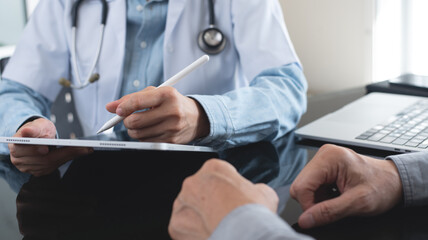 Wall Mural - Female asian doctor using digital tablet, writing prescription for her patient, medical screening, medical examination at medical clinic, close up