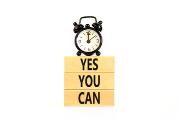 Poster - Motivational and Yes you can symbol. Concept words Yes you can on beautiful wooden blocks. Beautiful white background. Black alarm clock. Business motivational and Yes you can concept. Copy space.