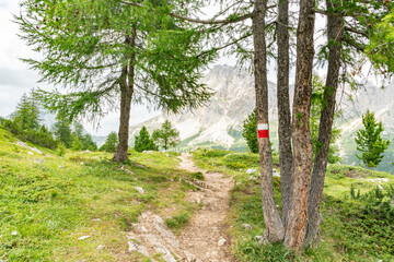 Hiking trail to Lago di Limides,  Lagazuoi mountain in the background. . Beautiful hiking place for active tourists. Magical hiking spot in the Italian dolomites mountain range. Red-white trail marks.