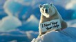 A polar bear holding a sign with the plea 