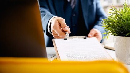 Wall Mural - Male arm in suit offer contract form on clipboard pad and silver pen to sign closeup. Strike a bargain for profit white collar motivation union decision corporate sale insurance agent concept