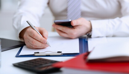 Wall Mural - Male arm in suit and tie hold silver pen filling schedule in notepad at office workplace closeup. Legal law consult assistance gesture or finance investment advisor clerk job information gesture