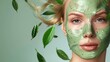 Woman with green face mask surrounded by flying leaves, nature skincare concept