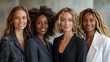 Four confident businesswomen smiling in professional attire against a blurred office background. 