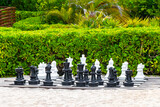 Fototapeta Most - Giant large chess pieces on chessboard outside on beach Mexico.