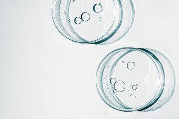 Wall Mural - Petri dish. Petri cups with liquid. Kit. Chemical elements, oil, cosmetics. Gel, water, molecules, viruses. Close-up. On a white background.