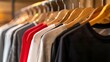 Assorted T-Shirts on Wooden Hangers Displayed in a Store. Fashion Retail Concept with a Variety of Casual Clothes. Stylish and Simple Garment Selection in a Shop. AI