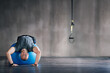 © peopleimages.com - Man, physio ball and stretch for back strength, health or wellness in fitness studio. Sports trainer, working out and demonstrating exercise for motivation, lumbar mobility and flexibility in gym