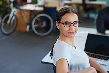 Canvas Print - Woman, office and desk in portrait with confidence for career with work in administration job. Female person, workplace and table with laptop for review, feedback and online research with technology