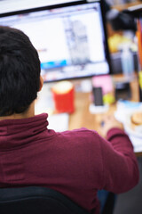 Wall Mural - Rear view, IT employee and computer in office with software for information technology, web development and programming. Young person or man with digital tech for cyber security database and internet